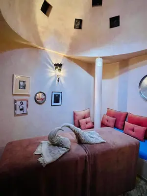 a bedroom with a large bed with red pillows at Exclusive and stylish 4-bedroom Riad with plunge pool in Marrakech