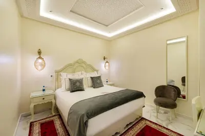 a bedroom with a large bed and a mirror at HOTEL RIAD CHAMI in Marrakech