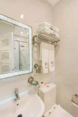 a bathroom with a sink and a mirror and a toilet at HOTEL RIAD CHAMI in Marrakech