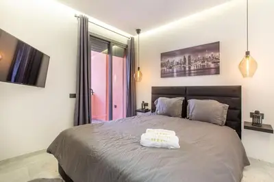 a bedroom with a large bed with a white towel on it at New! lovely and cosy flat, like at home in Marrakech