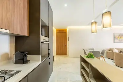 a kitchen and living room with a couch and a table at New! lovely and cosy flat, like at home in Marrakech