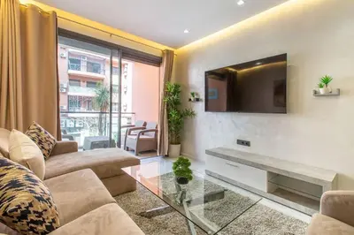 a living room with a couch and a tv at New! lovely and cosy flat, like at home in Marrakech