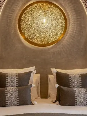 a bedroom with a large chandelier above a bed at Riad Almisk in Marrakech