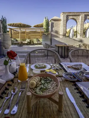 a table with a bowl of food on top of it at Riad Almisk in Marrakech