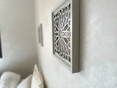 a white wall with a metal plate on a wall at Lovely family condo in residence Marrakech in Marrakech