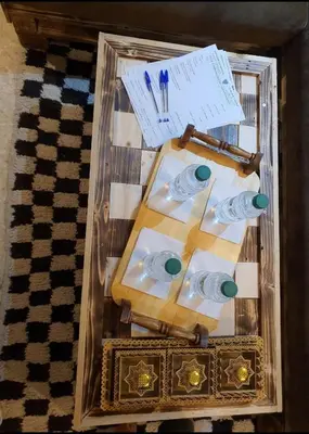 a plastic box with a table with three cups and a pen at studio funny house près de la grande place jamaa el fna in Marrakech