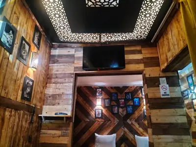 a room with wooden walls and a flat screen tv at studio funny house près de la grande place jamaa el fna in Marrakech