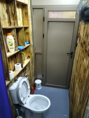 a small bathroom with a toilet and a door at studio funny house près de la grande place jamaa el fna in Marrakech