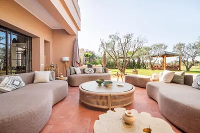 a living room with couches and a coffee table at Villa May sur le Golf de la Palmeraie with Cooker and Butler included in Marrakech
