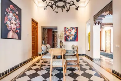 a dining room with a table and chairs at Villa May sur le Golf de la Palmeraie with Cooker and Butler included in Marrakech