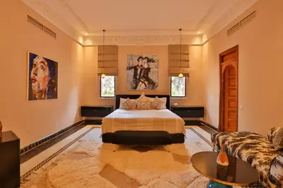 a bedroom with a bed and a couch at Villa May sur le Golf de la Palmeraie with Cooker and Butler included in Marrakech