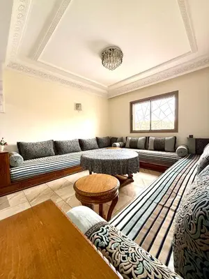a living room with a couch and a table at Appartement en résidence privée in Marrakech