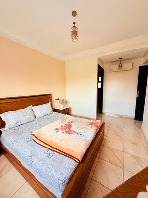 a bedroom with a large bed in a room at Appartement en résidence privée in Marrakech