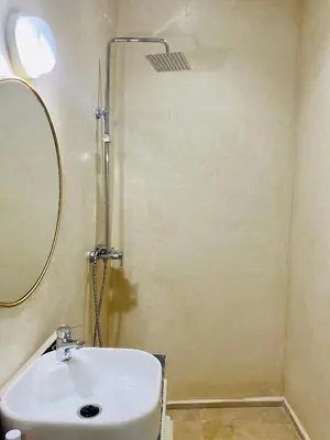 a bathroom with a sink and a shower at DAR Riad Jomana in Marrakech