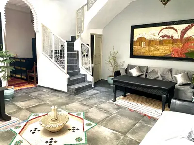 a living room with a couch and a piano at DAR Riad Jomana in Marrakech