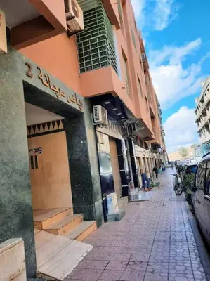 a city street with a building and a car parked on the street at Espace Harmony in Marrakech