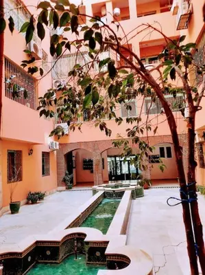 a courtyard with a swimming pool in a building at Espace Harmony in Marrakech