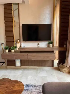 a living room with a large flat screen tv at Duplex Cosy dans résidence avec piscine in Marrakech