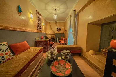 a living room with a couch and a table at Riad Azawan in Marrakech
