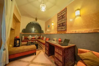 a living room with a desk with a laptop on it at Riad Azawan in Marrakech