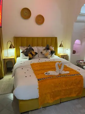 a bedroom with a bed with a stuffed animal on it at RIAD KECHMARA in Marrakech