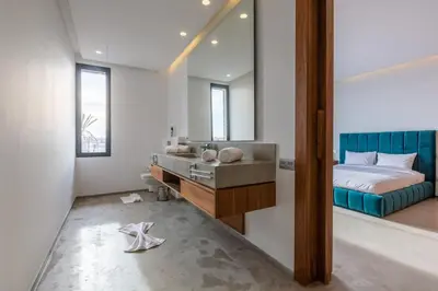 a bathroom with a sink and a bed and a mirror at VILLA 103 - Luxury Getaway - Private Jacuzzi in Marrakech