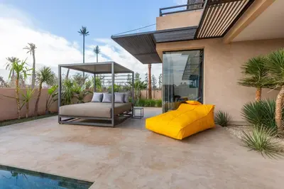 a bed sitting on a patio next to a pool at VILLA 103 - Luxury Getaway - Private Jacuzzi in Marrakech