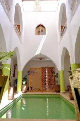 an indoor pool in a building with an archway at Riad Petite Rose in Marrakech