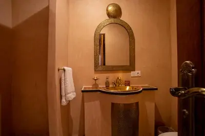 a bathroom with a sink and a mirror at Riad Petite Rose in Marrakech