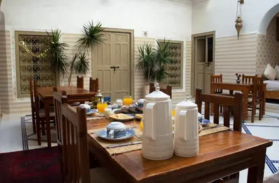 a dining room with a table with food on it at Riad Marana Hotel & Spa in Marrakech