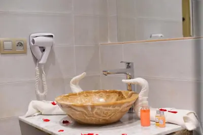 a bathroom with a bowl sink and a phone at Riad Marana Hotel & Spa in Marrakech