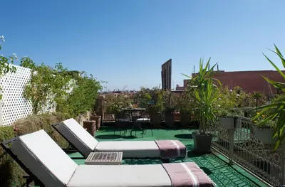a rooftop garden with a view of the city at Riad Marana Hotel & Spa in Marrakech