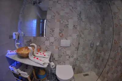 a bathroom with a mirror and a toilet and a sink at Riad Marana Hotel & Spa in Marrakech