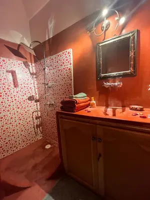 a bathroom with a shower with a sink and a mirror at riad dar saba shika in Marrakech