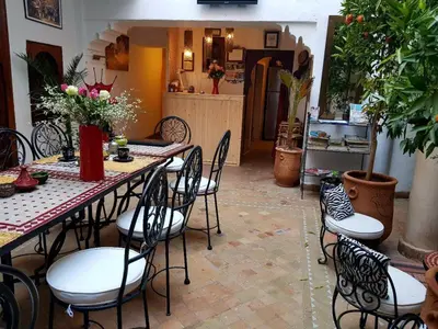 a dining room with a table and chairs at riad dar saba shika in Marrakech