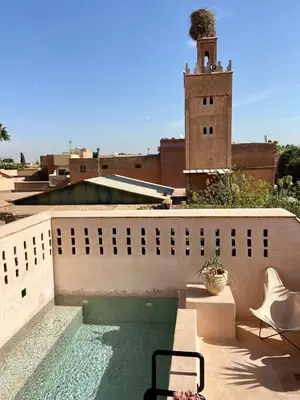 a swimming pool on the roof of a building at Riad Doum Collection 1 in Marrakech
