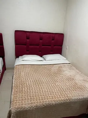 a bed with a red headboard in a room at 1er étage numéro 5 avec balcon POUR FAMILLE in Marrakech