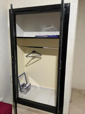 a glass door of a closet with a shelf at 1er étage numéro 5 avec balcon POUR FAMILLE in Marrakech