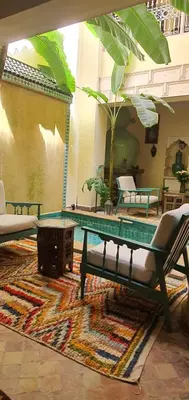 a living room with a pool table and chairs at RIAD DAR NAOMI in Marrakech