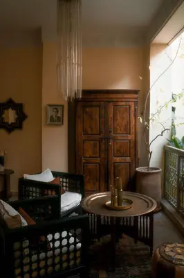 a living room with a table and chairs at RIAD DAR NAOMI in Marrakech