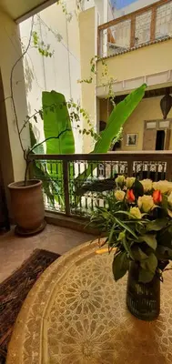 a vase of flowers on a table in a room at RIAD DAR NAOMI in Marrakech