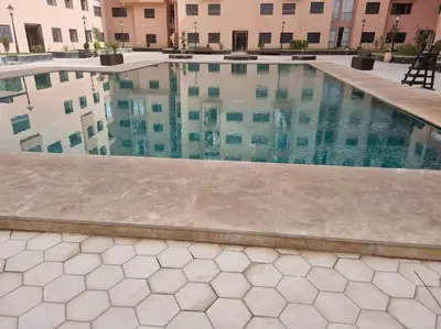 a swimming pool in front of a building at Appartement résidence Marrakech haut standing piscine in Marrakech