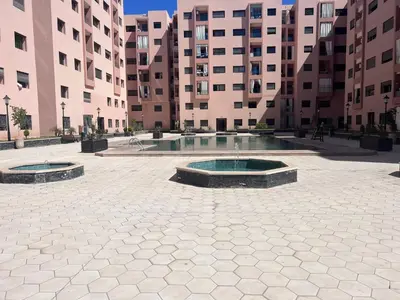 a courtyard with two fountains in front of buildings at Appartement résidence Marrakech haut standing piscine in Marrakech