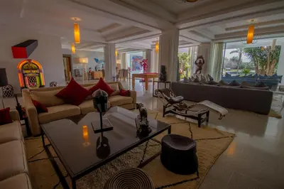 a living room with a couch and a table at Villa Fima Kech in Marrakech