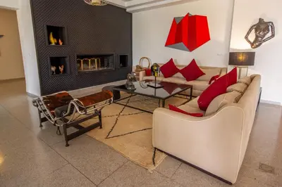 a living room with a couch and a fireplace at Villa Fima Kech in Marrakech