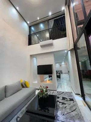 a living room with a couch and a fireplace at Appartement en Duplex avec 3 chambres Haut Standing Gueliz Marrakech in Marrakech