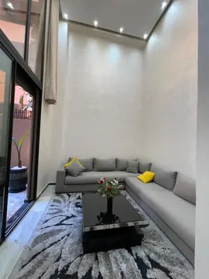 a living room with a couch and a table at Appartement en Duplex avec 3 chambres Haut Standing Gueliz Marrakech in Marrakech