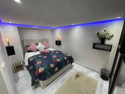 a bedroom with a bed with a floral bedspread at Appartement en Duplex avec 3 chambres Haut Standing Gueliz Marrakech in Marrakech