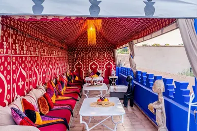 a room with red and blue walls and couches at Riad Zehar 79 & Spa in Marrakech