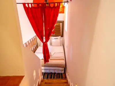 a stairway with a red curtain in a room at Riad Zehar 79 & Spa in Marrakech